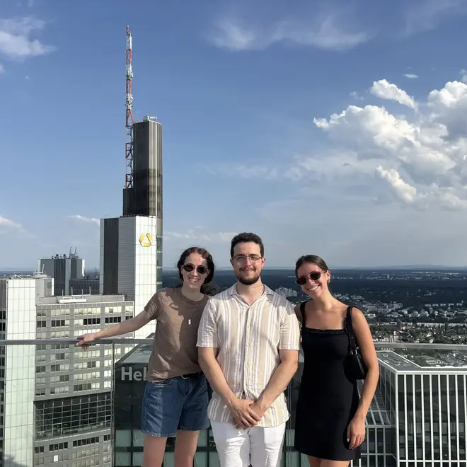 a group of people posing for a picture on a rooftop