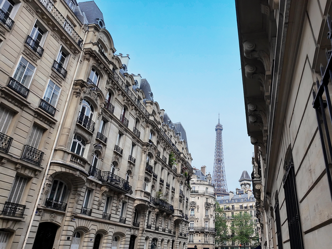 a street with buildings and a tower in the background