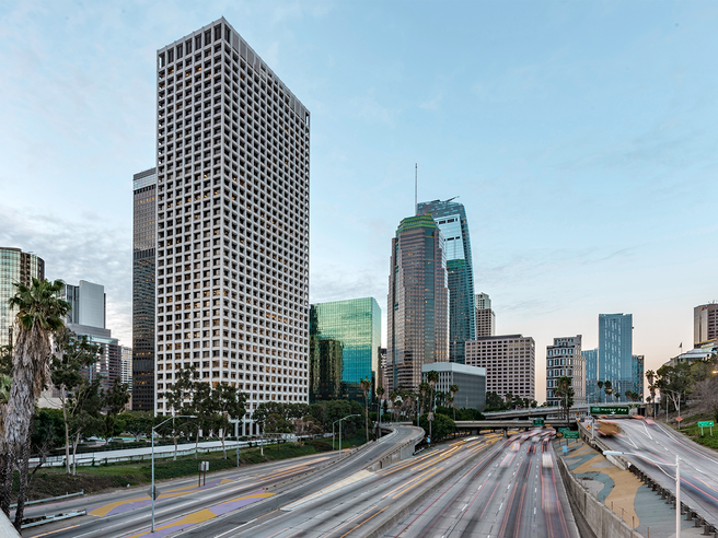 a city with tall buildings and a freeway