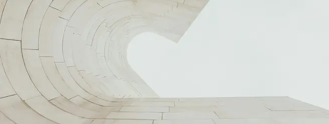 a white stone wall with a curved arch