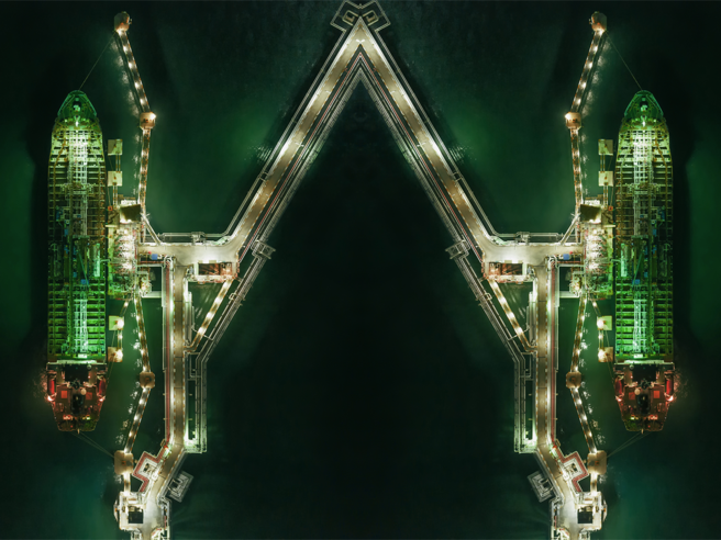 a group of ships in a port at night