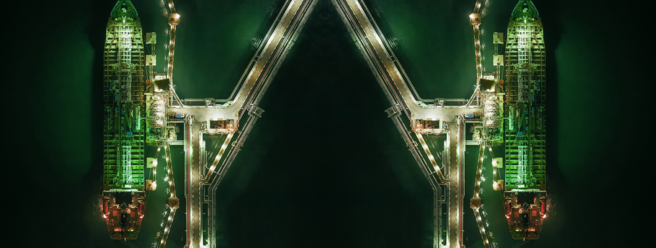 a group of ships in a port at night