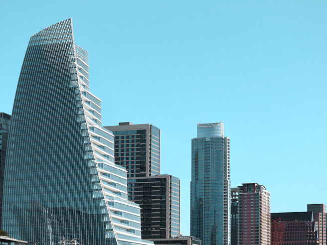a tall glass building with a triangular shaped top
